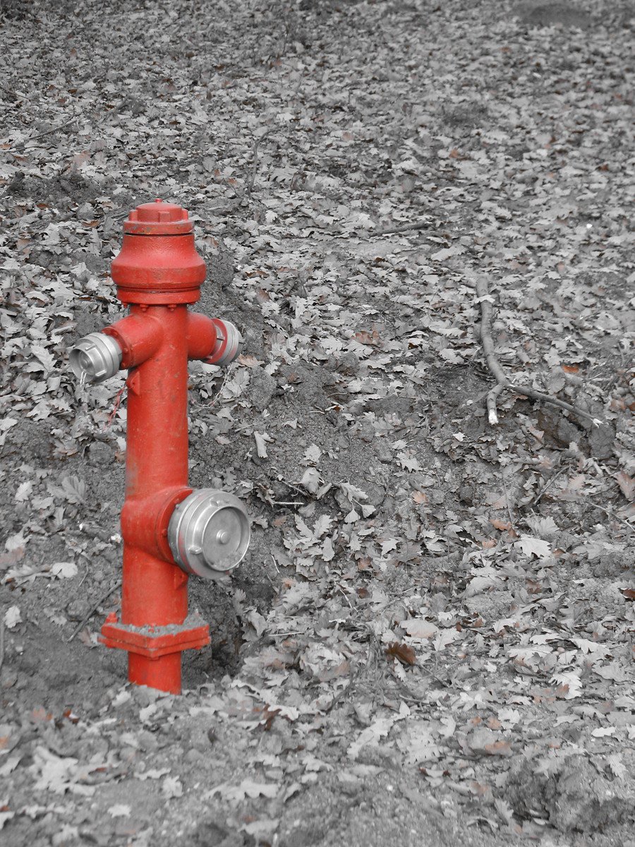 red fire hydrant in the middle of rocky ground