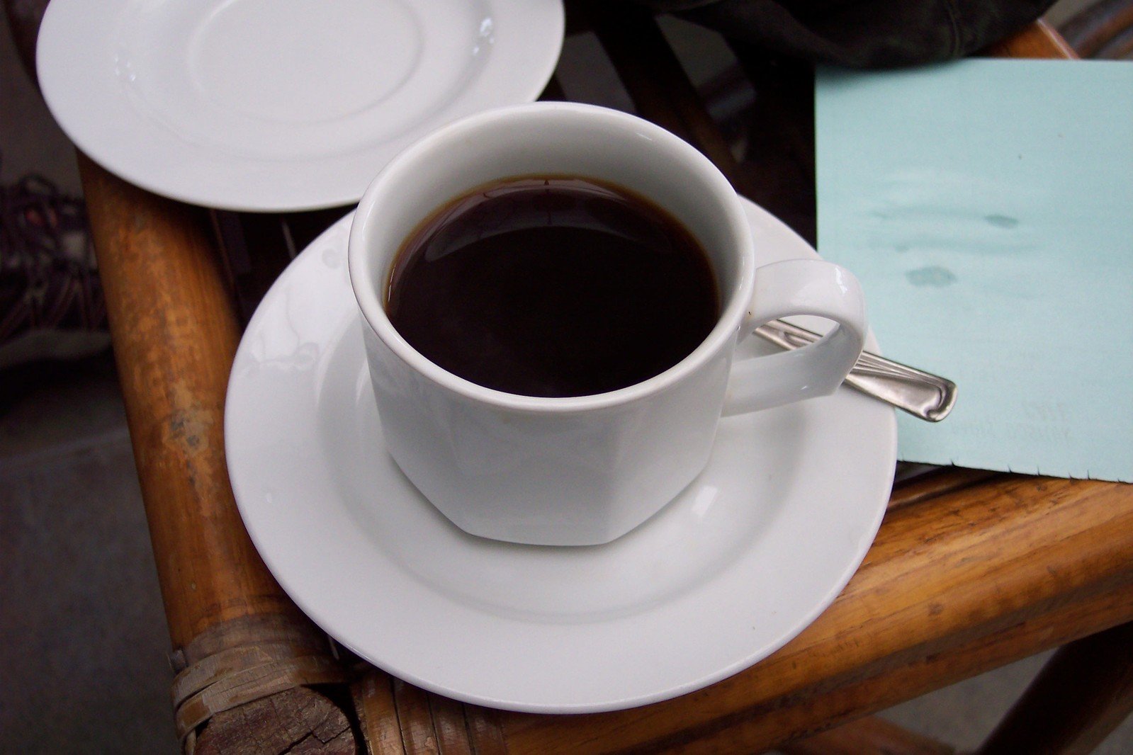 cup of coffee sitting on a wooden table