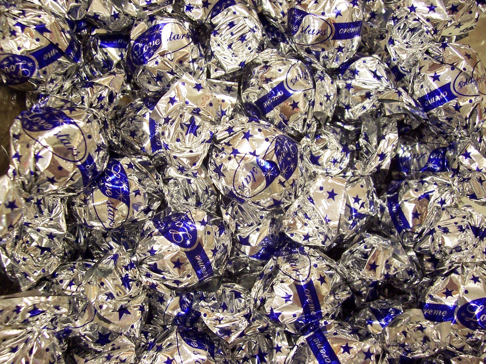 a pile of shiny foil wrapped in blue and silver ribbons