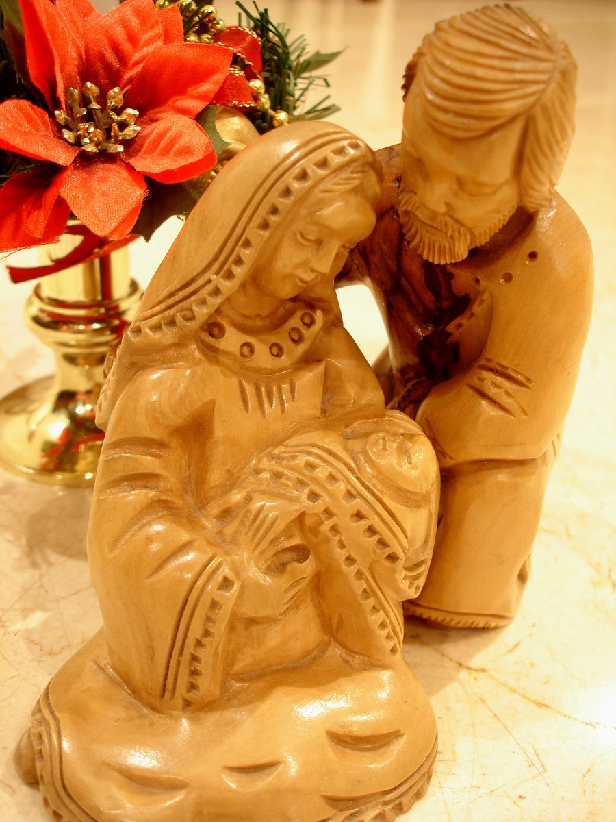 a wooden carving of two people touching noses