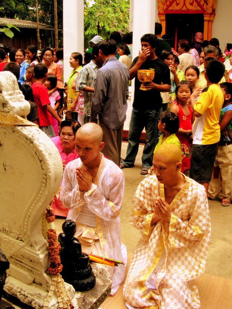 people praying at an outdoor ceremony on a sunny day