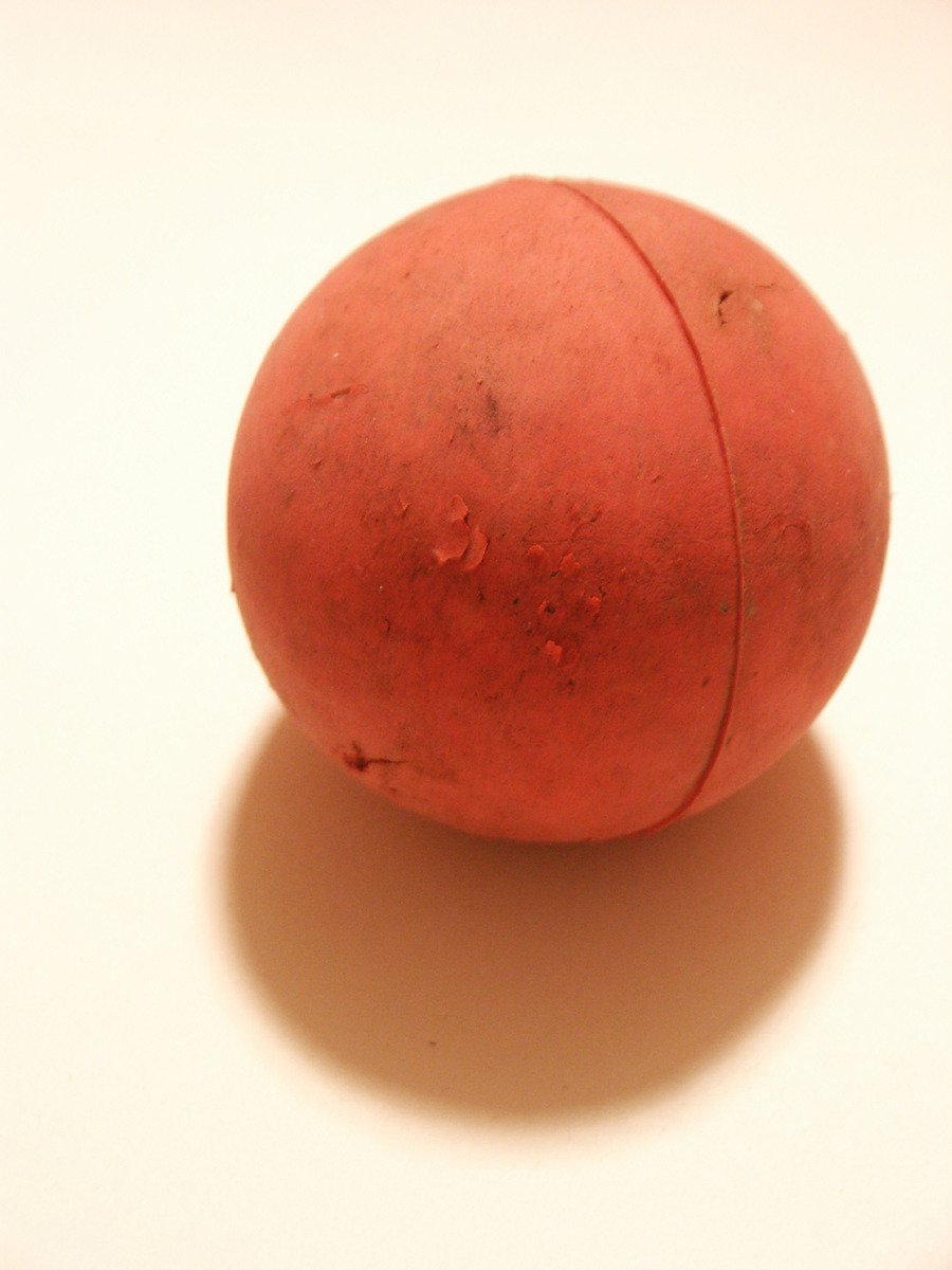 a red object laying on top of a white table