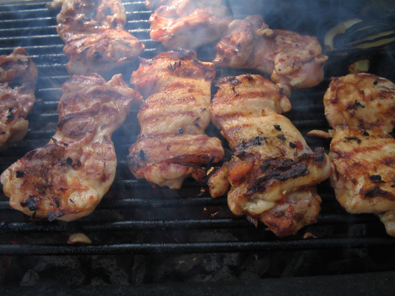 meat is being cooked on the grill for a meal