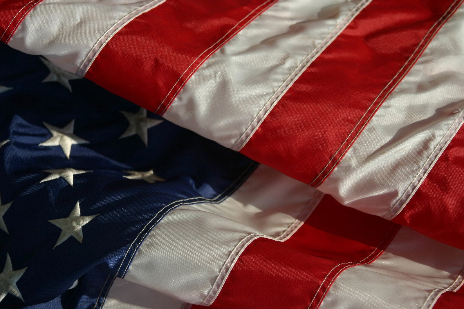 two american flags in close up against a white background