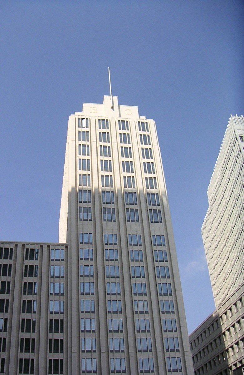 some very tall buildings against the blue sky