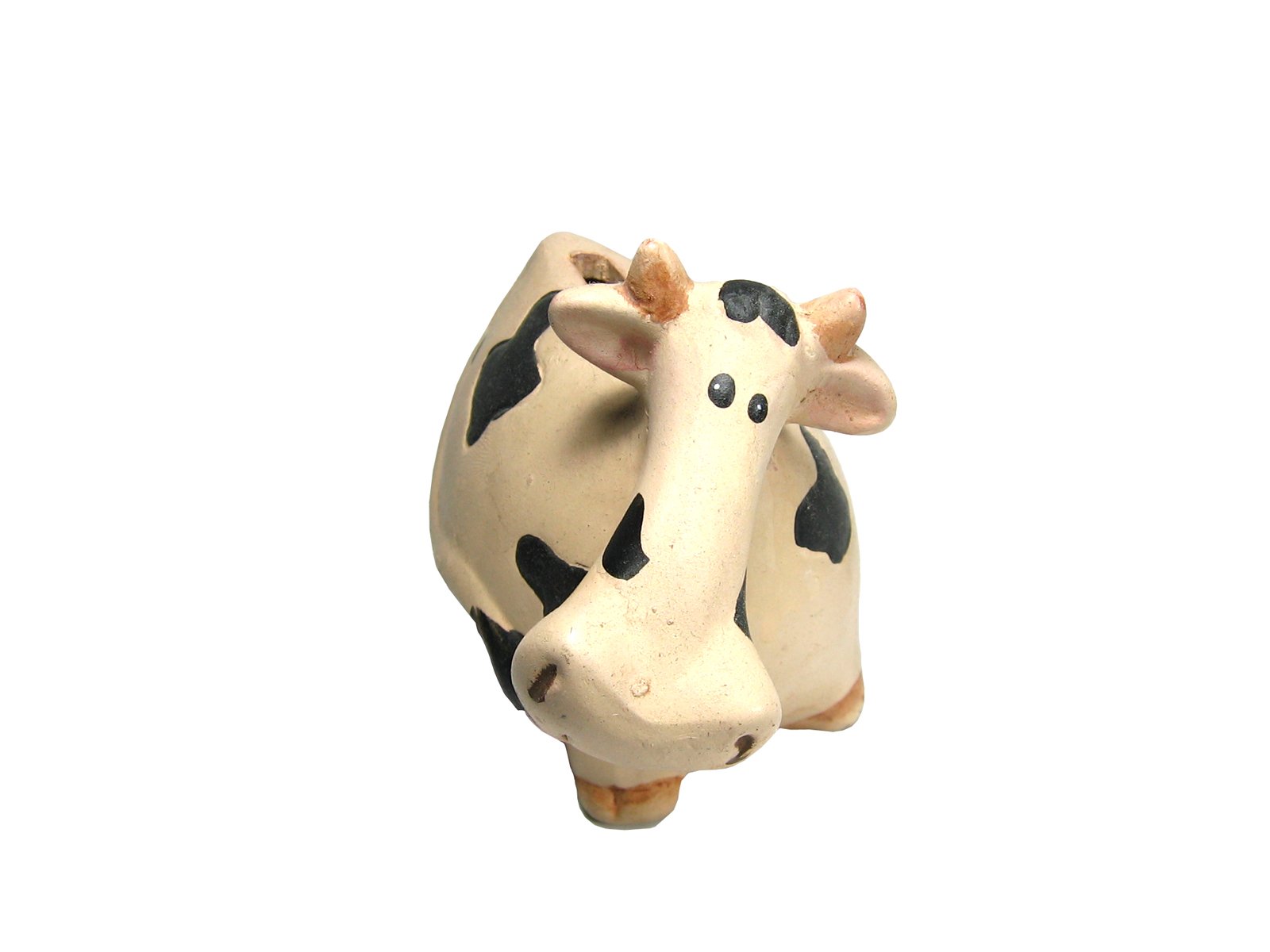 the ceramic cow is standing up and looking at the camera