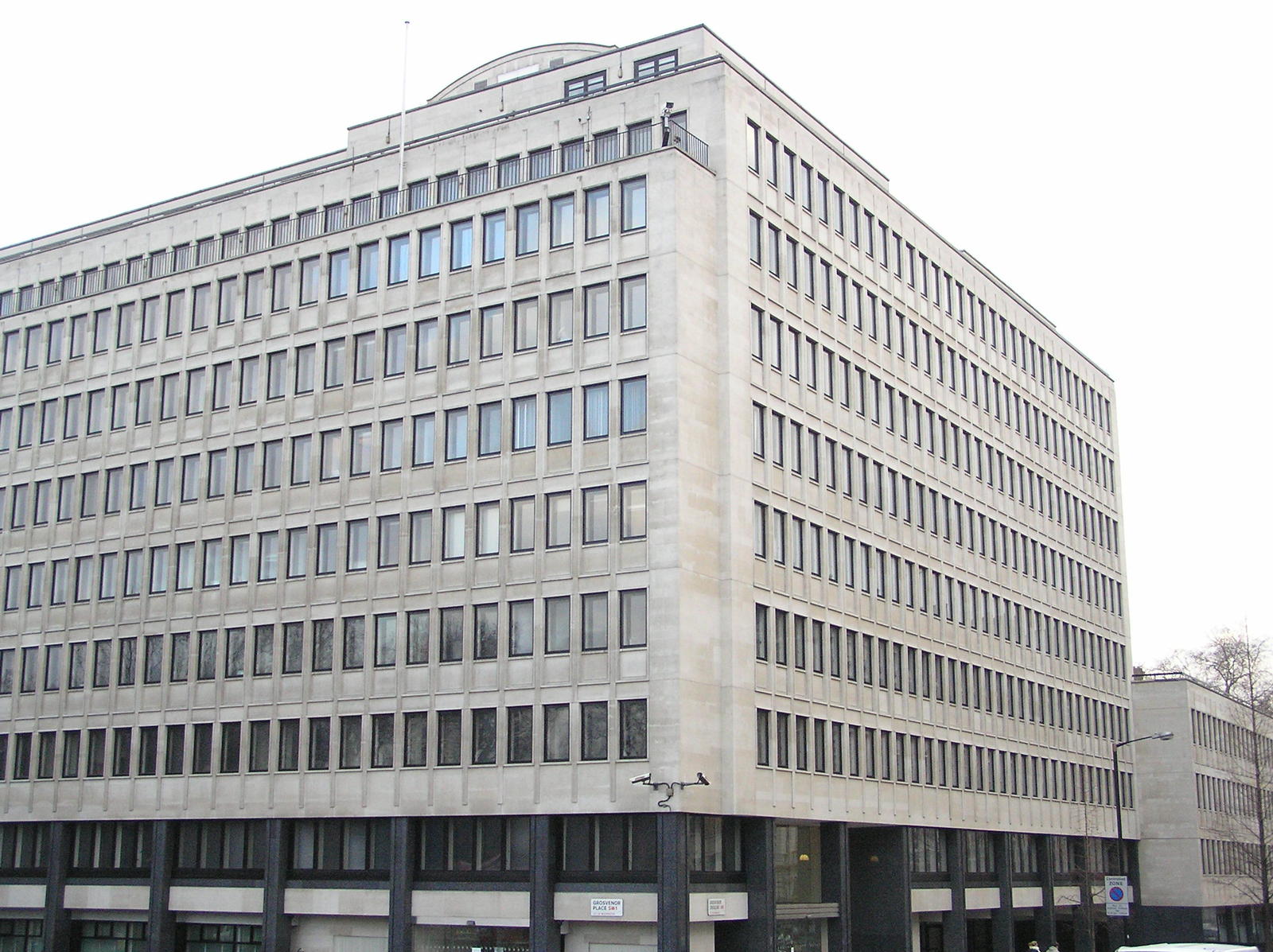 a large building with a sky line and cars on a street