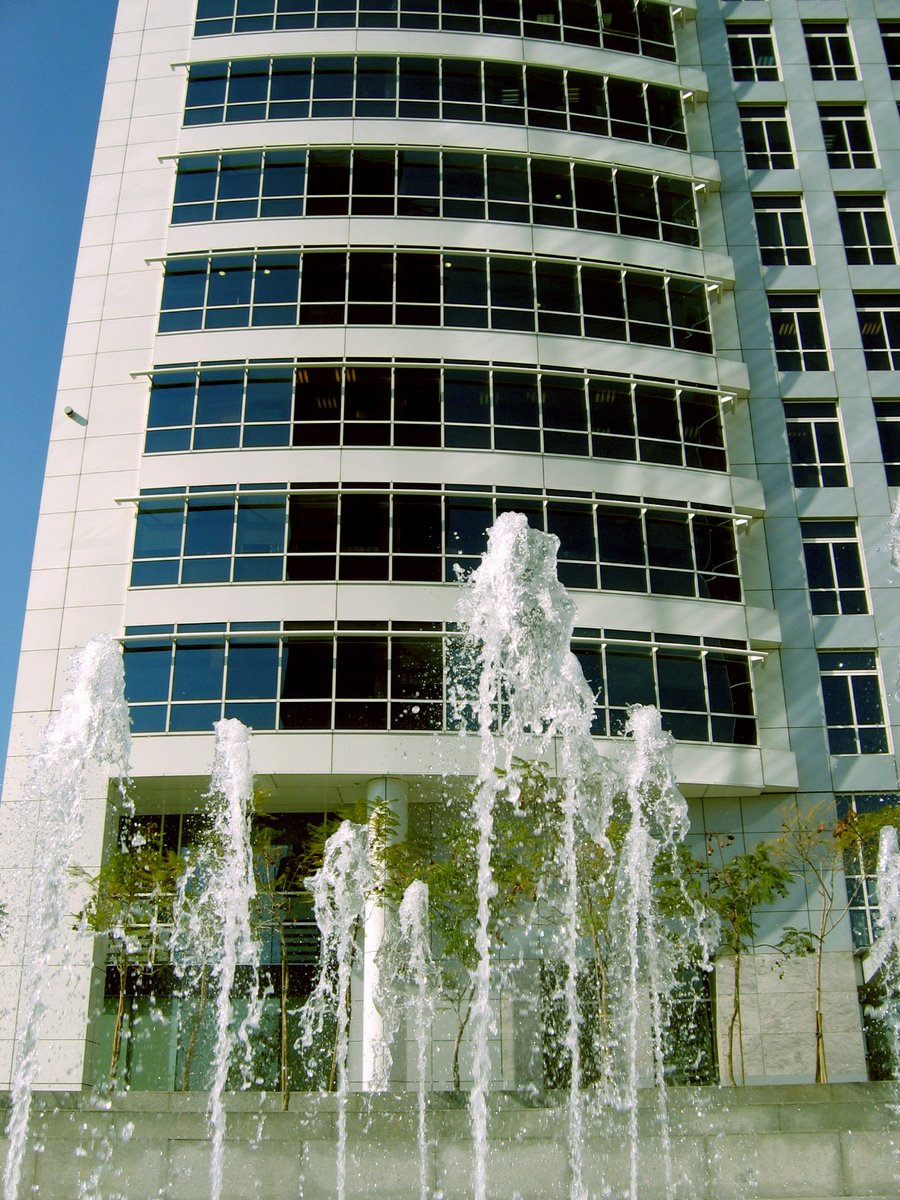 a big building that is very tall next to a fountain