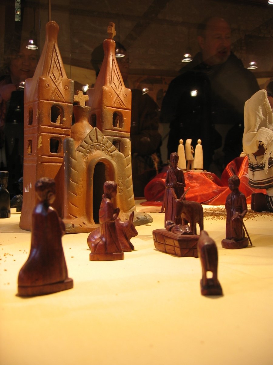 four pieces of wooden statues displayed on glass