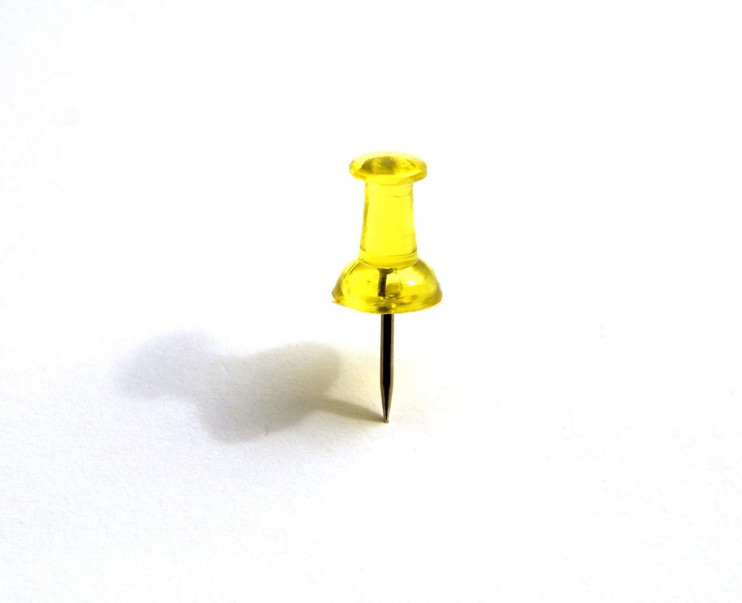 a small yellow object is posed on the ground