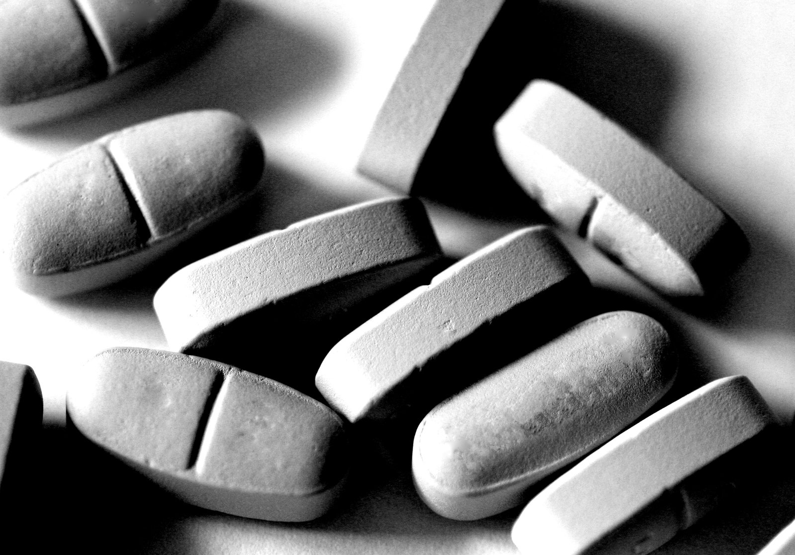 closeup of pills are displayed in black and white