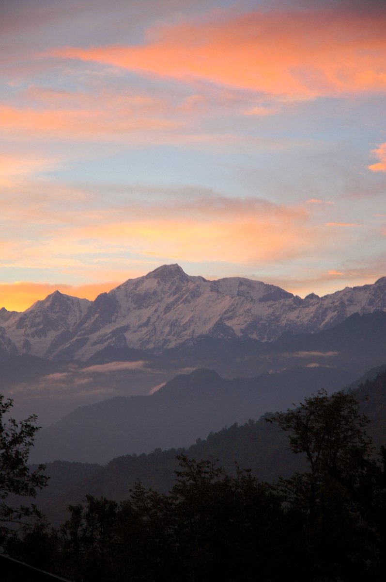 snow capped mountains in the distance in the evening