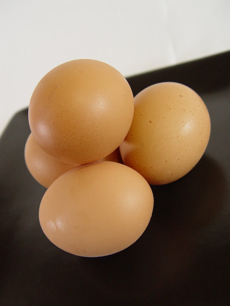 three brown eggs stacked on top of each other