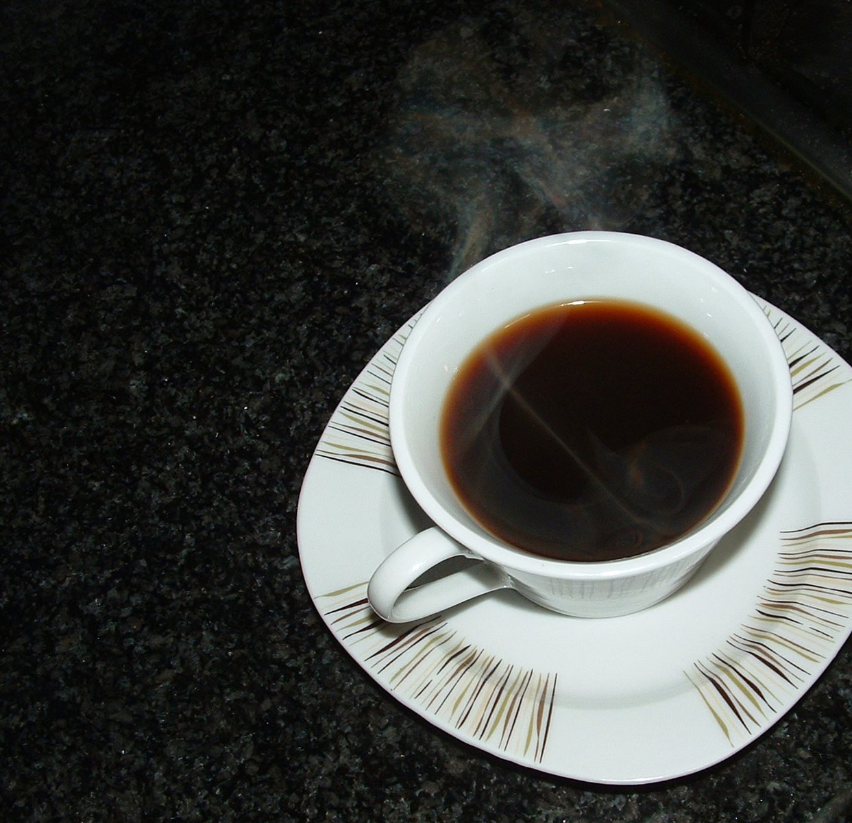 a white coffee cup sitting on top of a saucer
