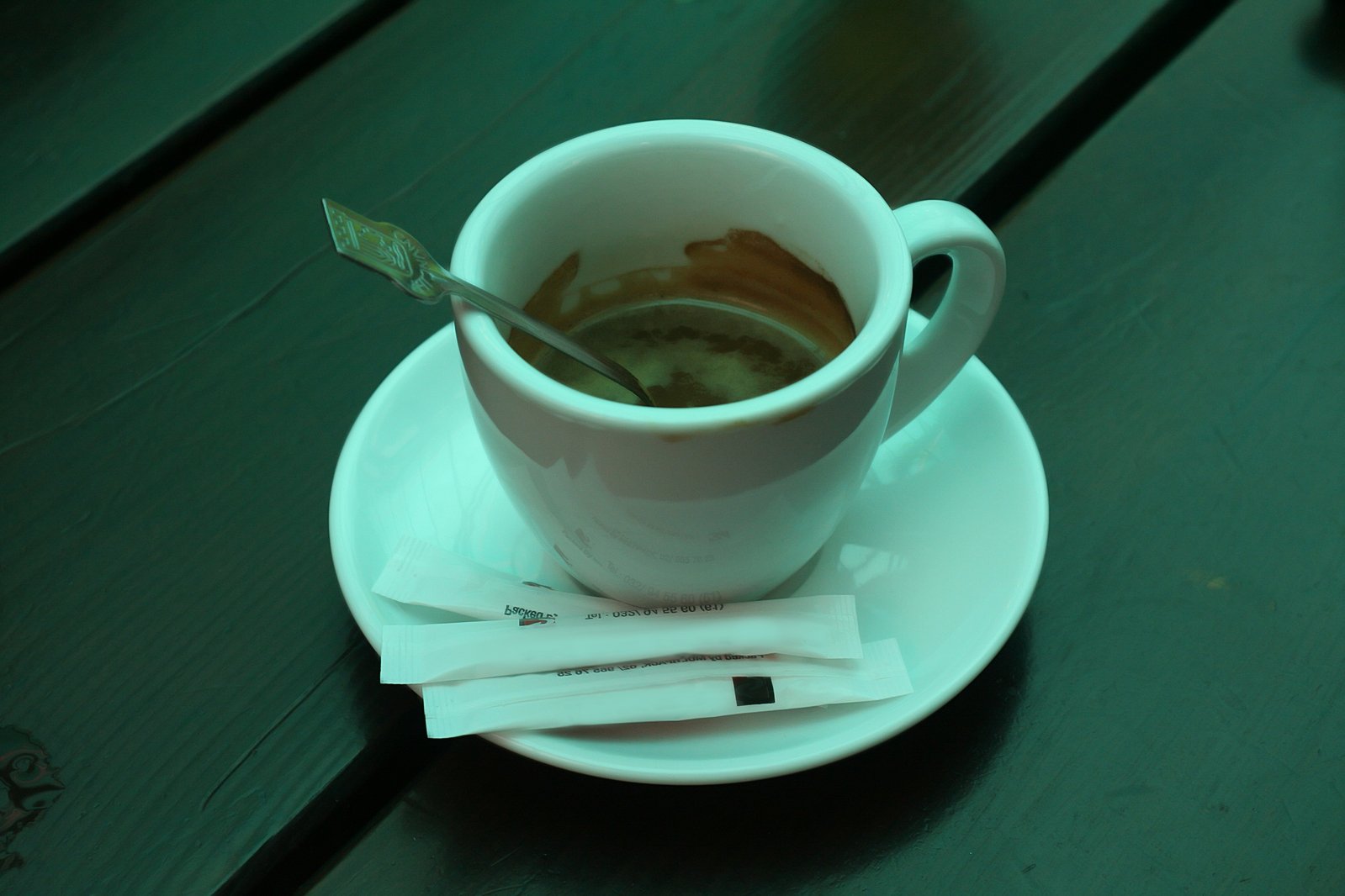 a coffee cup with a spoon in it on a saucer