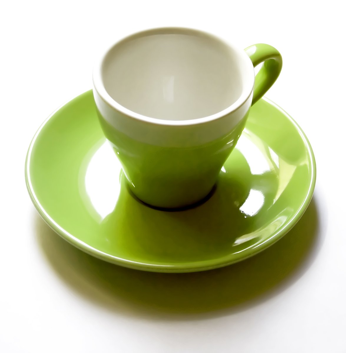 an empty green saucer on a bright green saucer