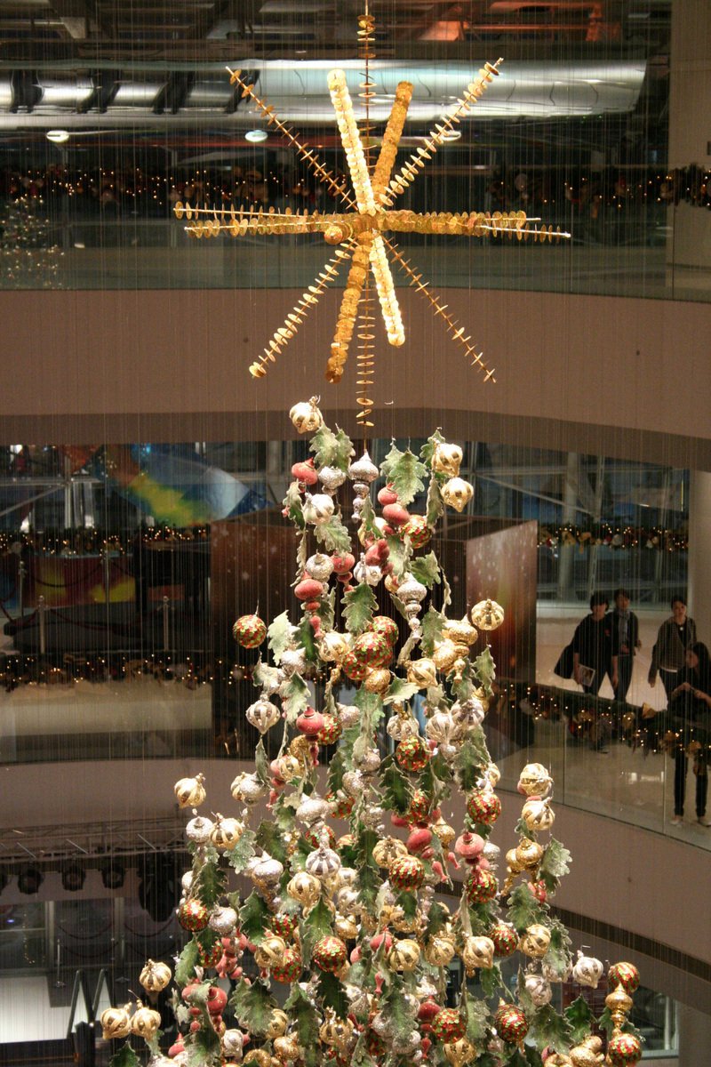 a christmas tree with ornaments on it and a star hanging from the top