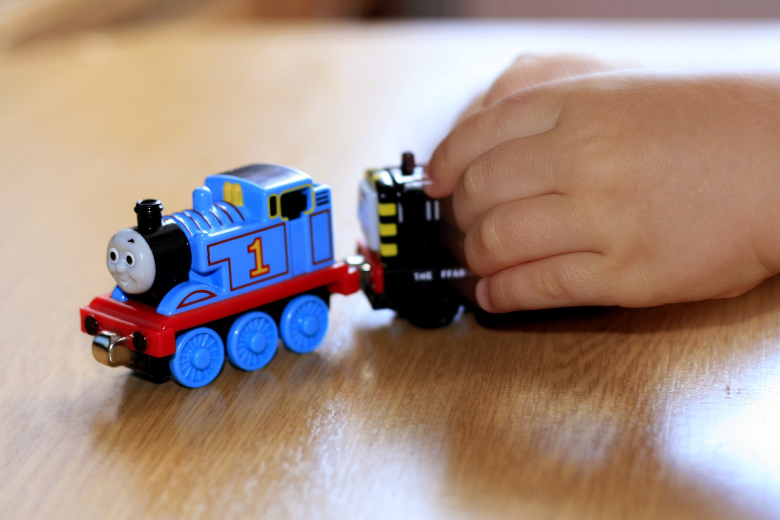 a child is playing with a toy train