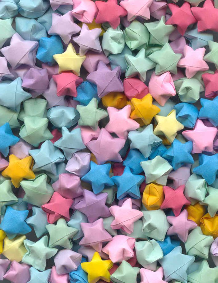 many colorful paper stars are scattered on the surface