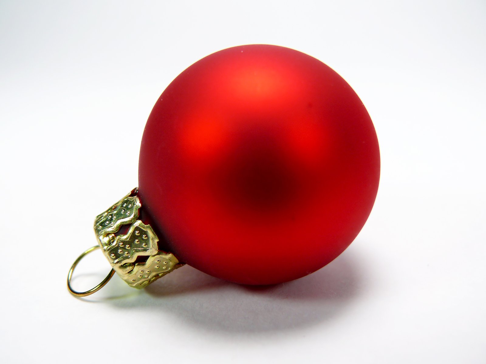 red christmas ornament on white background with gold decoration