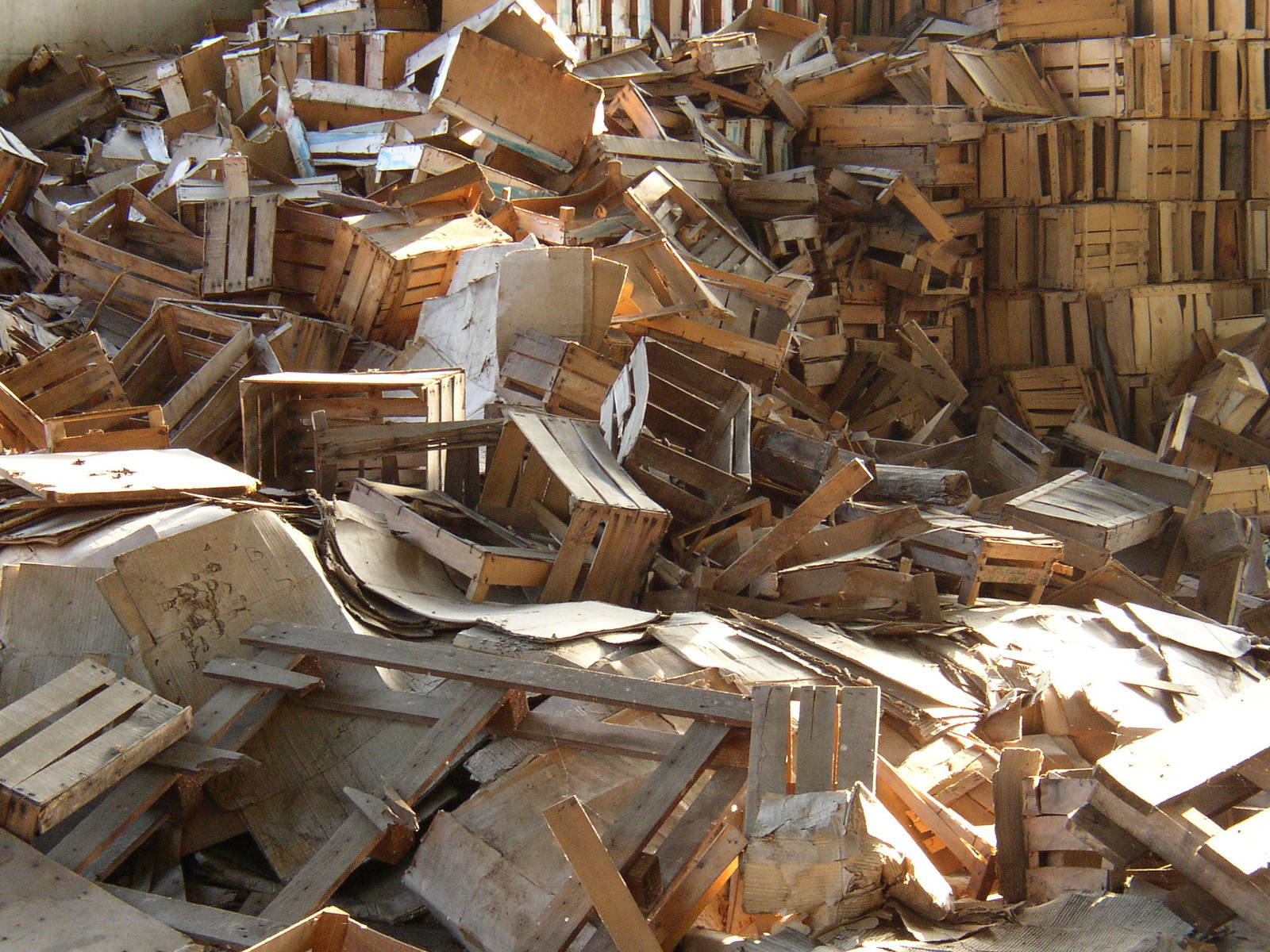 a very big pile of wooden boxes that are stacked up