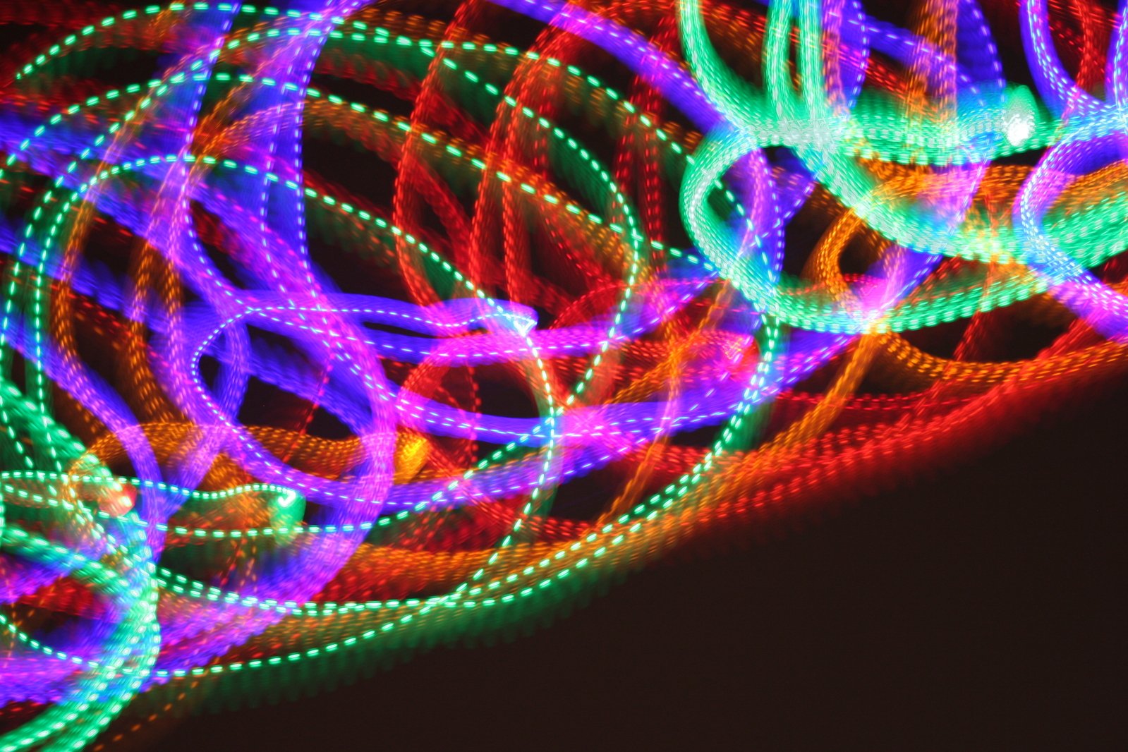 a close up of some glowing rings on a dark background