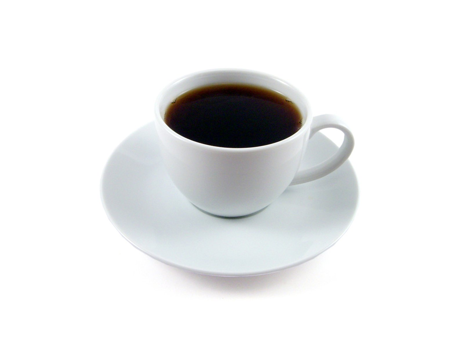 coffee is on a saucer that sits in the middle of a white plate