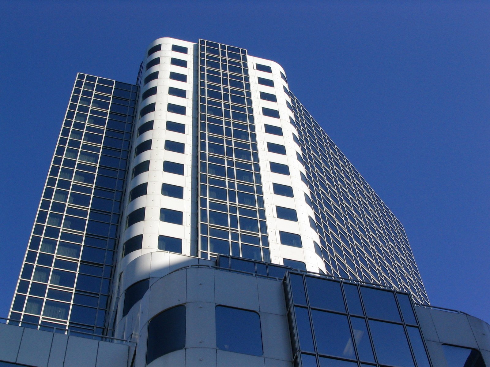 the top of a skyscr building looking up at its windows