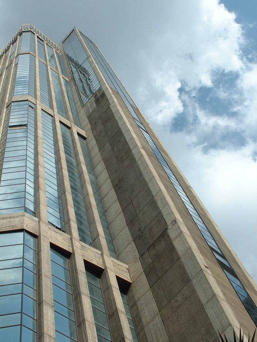 looking up at a high rise building with very large windows