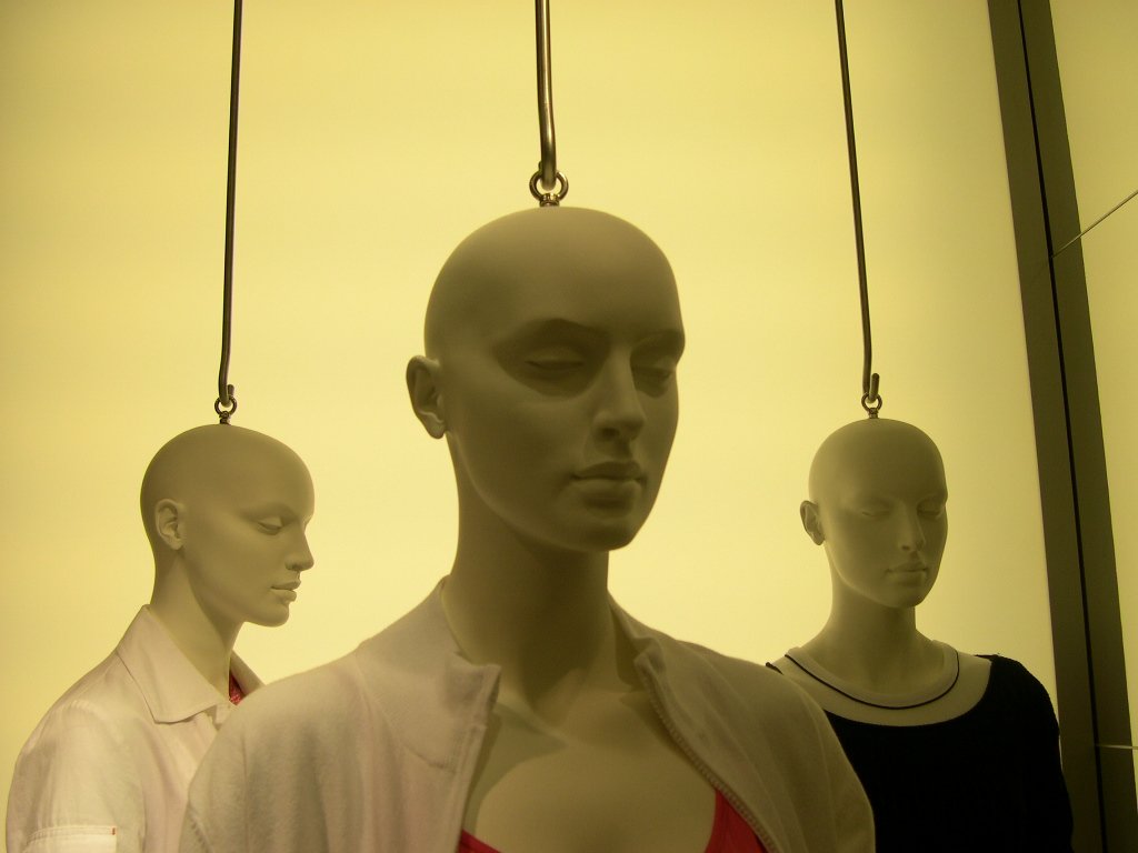 two mannequins in a display with one being a woman