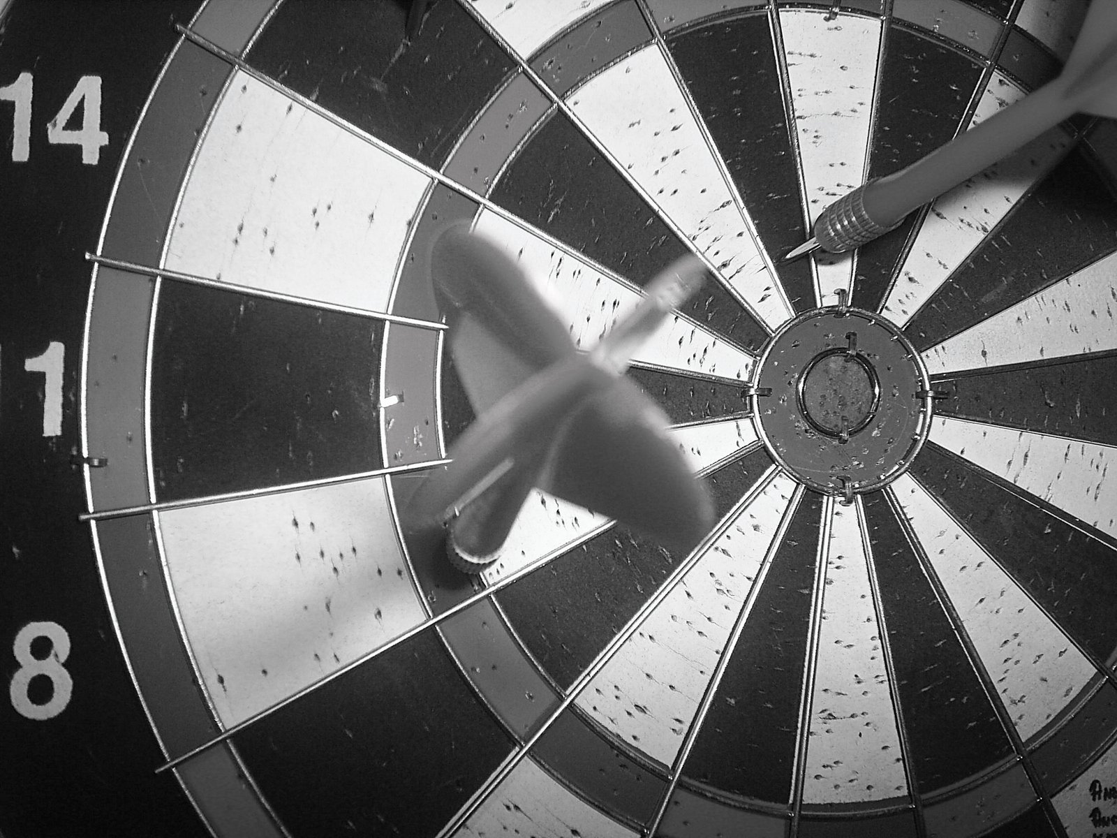 someones hand in the center of a dart hitting a bulls eye