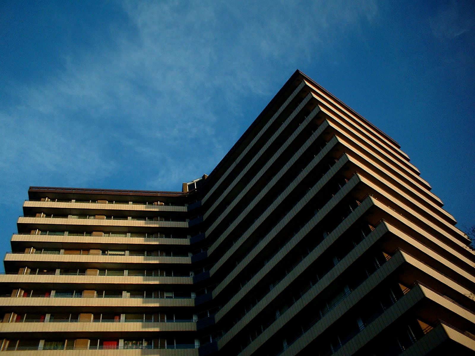 a tall brown building sitting in front of a blue sky