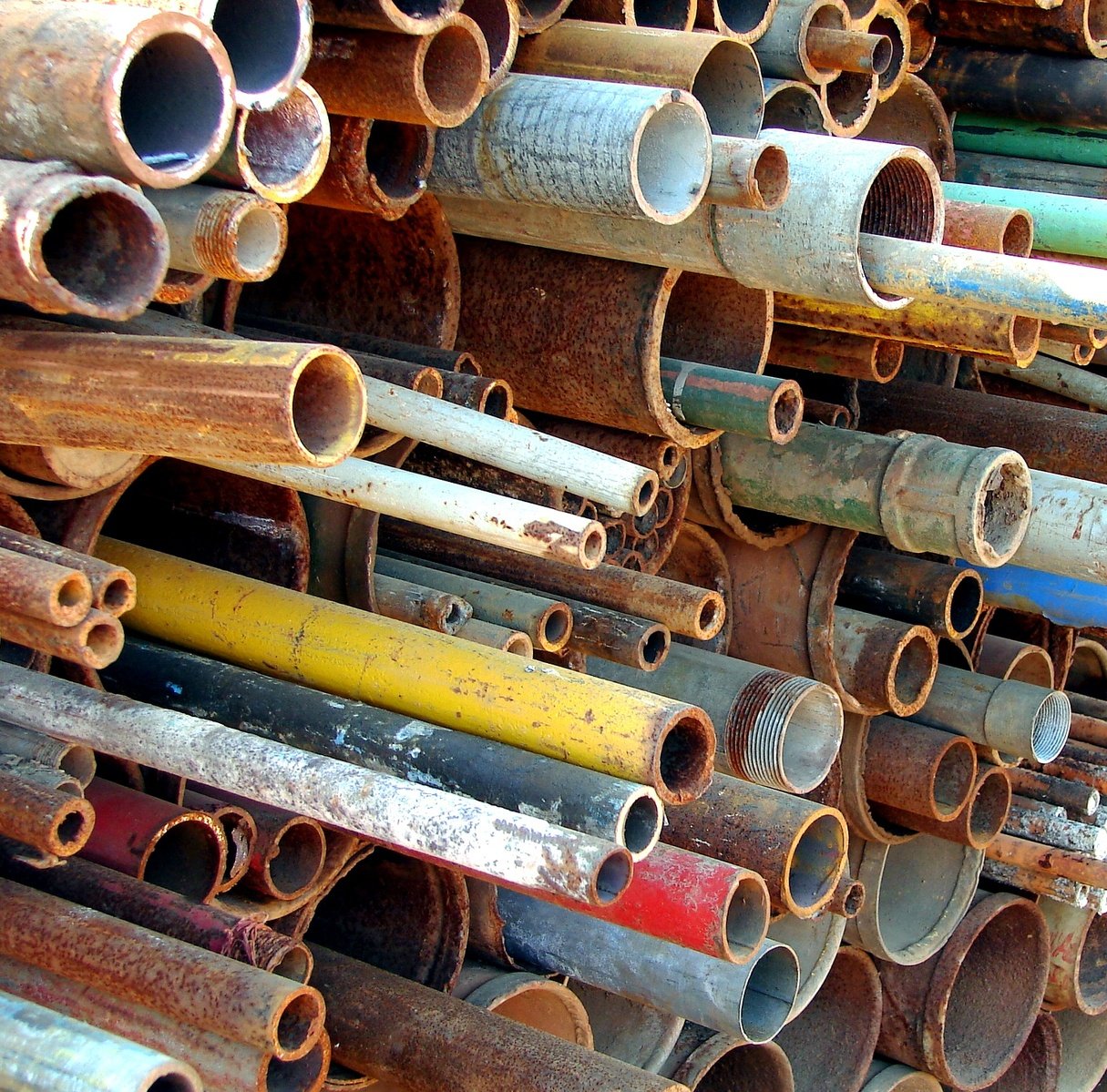 several pipes are stacked together with one being filled