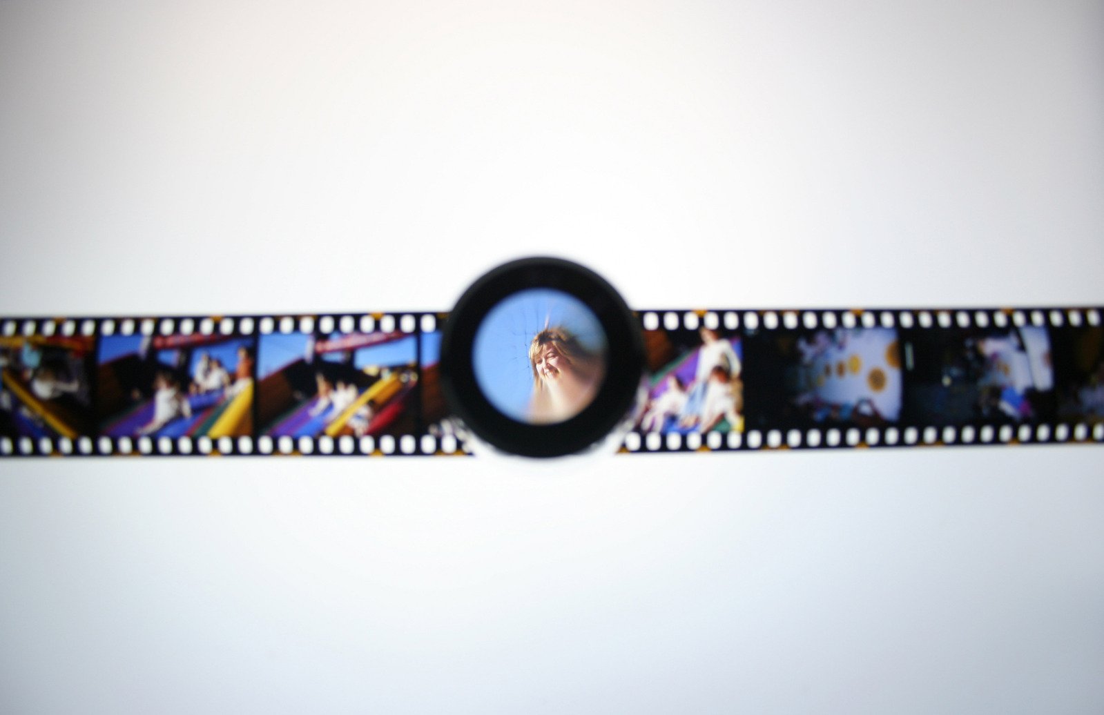 a film strip with film images and a small circle