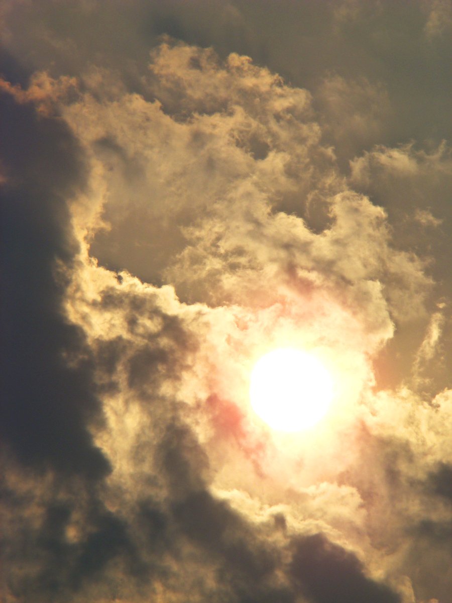 a jet is flying through a very cloudy sky