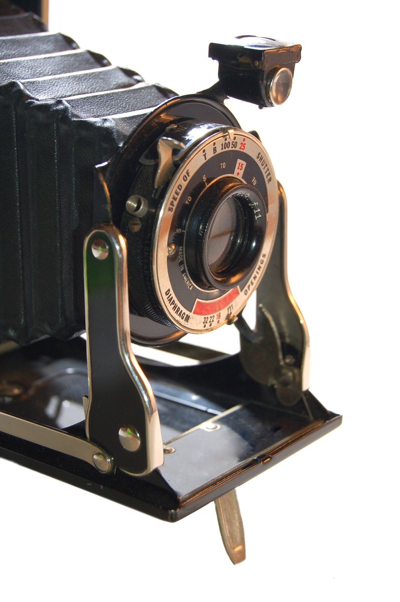 an old camera with a gold rim and focus lens