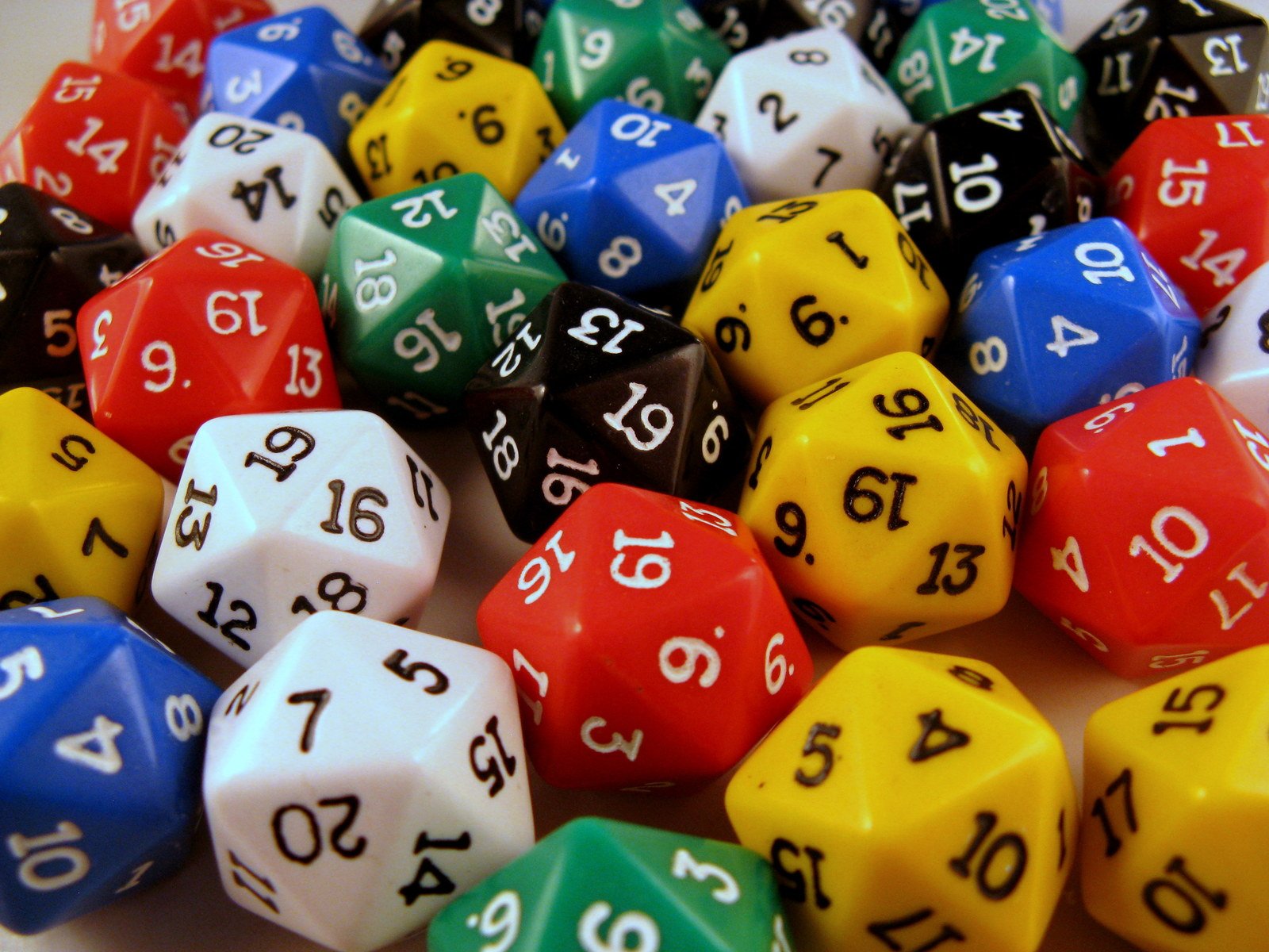 a variety of multi colored dice on white table