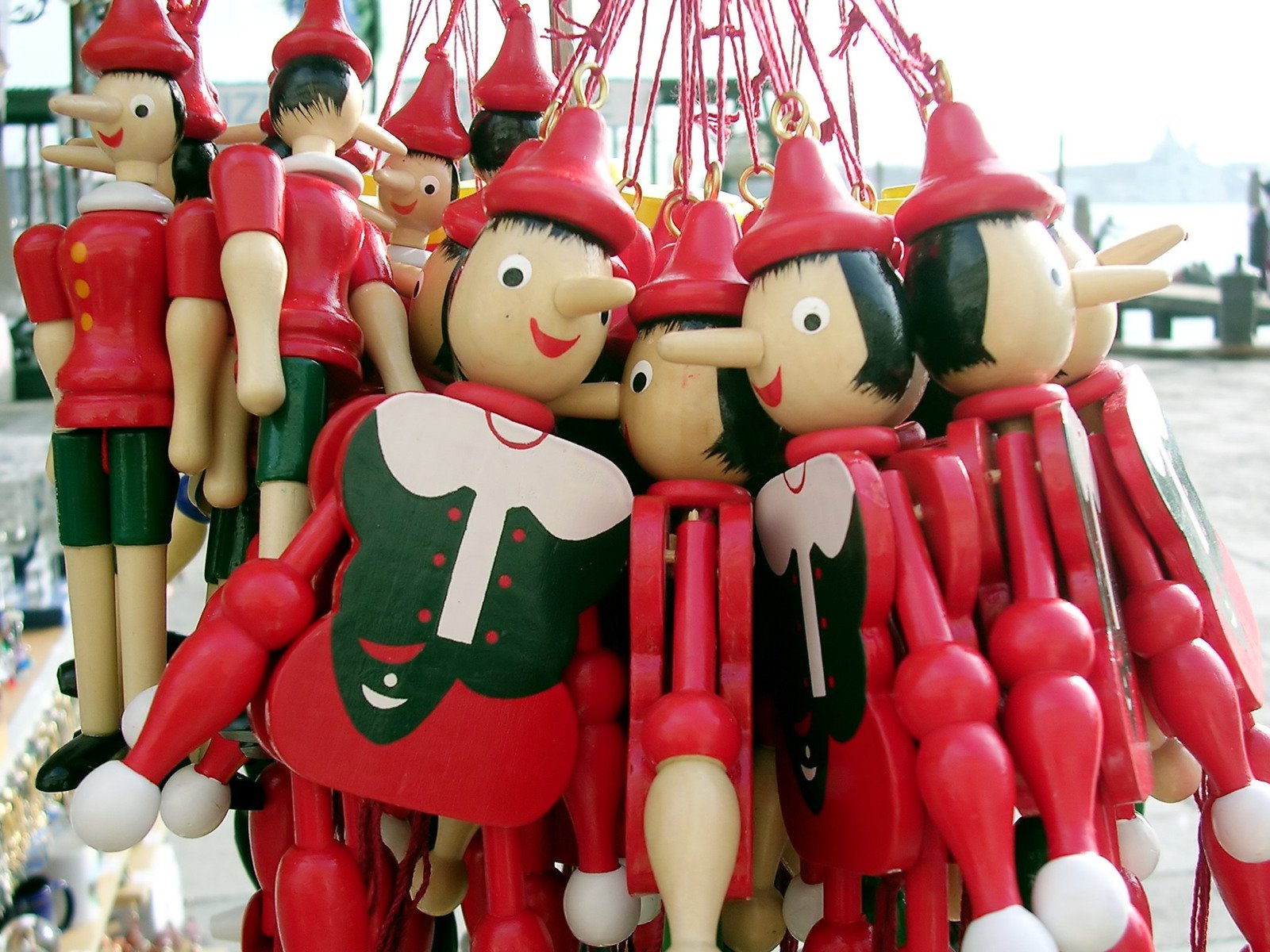 some people are holding onto red christmas decorations