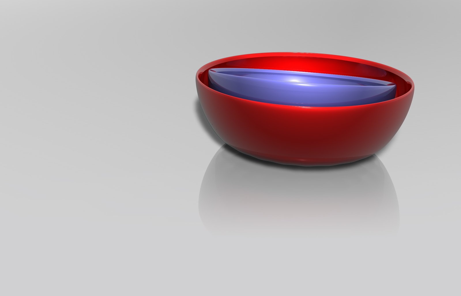 a red and purple bowl is on a gray table