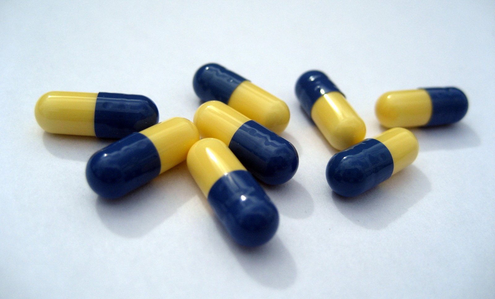 blue and yellow pills are shown in this image