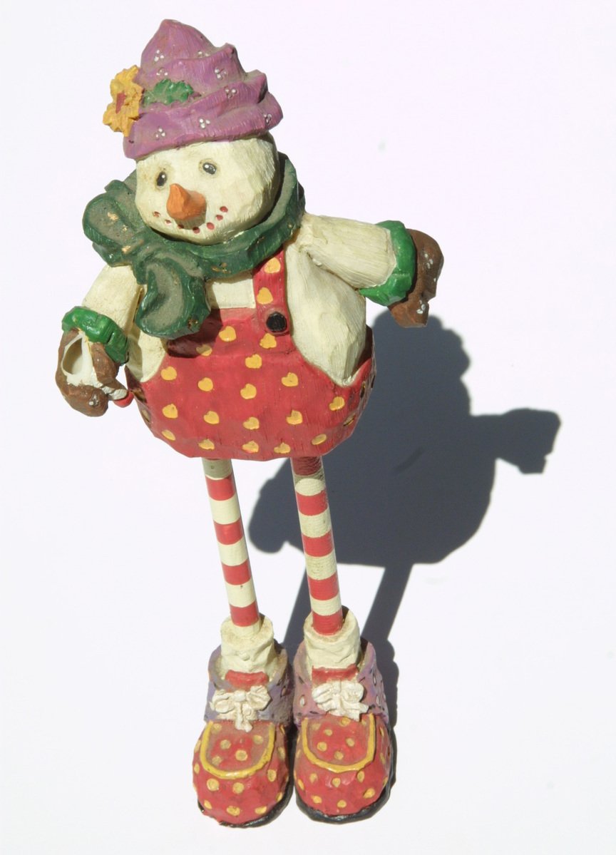 a ceramic snowman with red and white striped socks, hat and boots