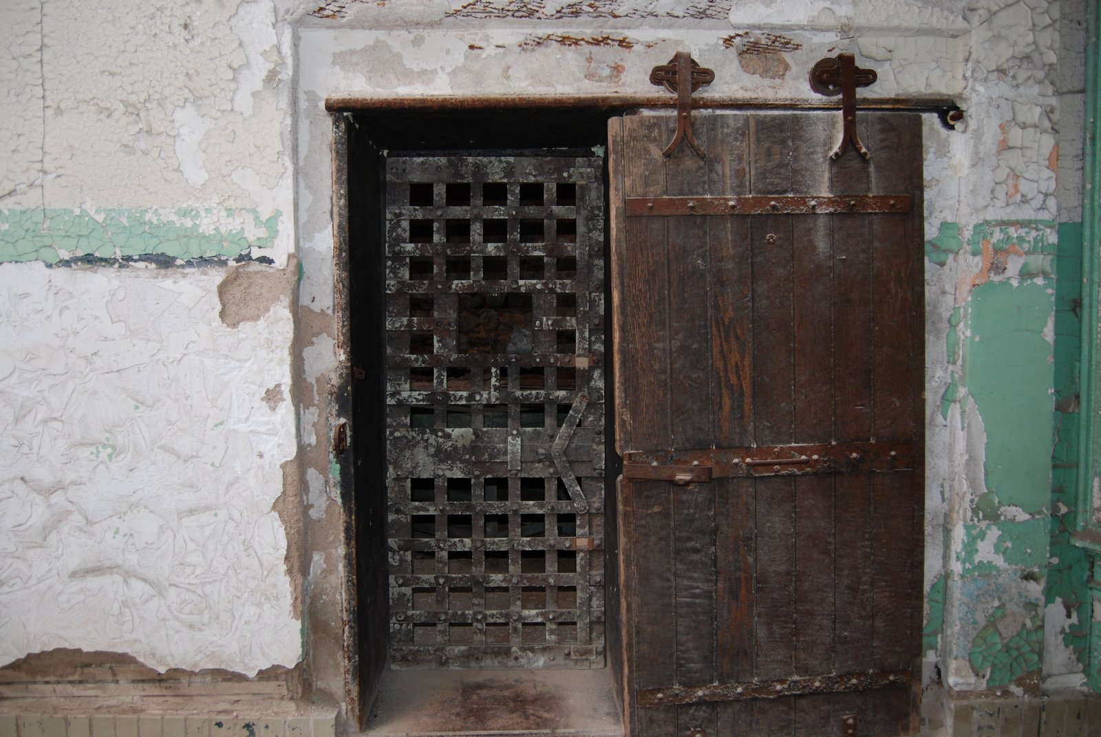 an old door with bars to separate rooms