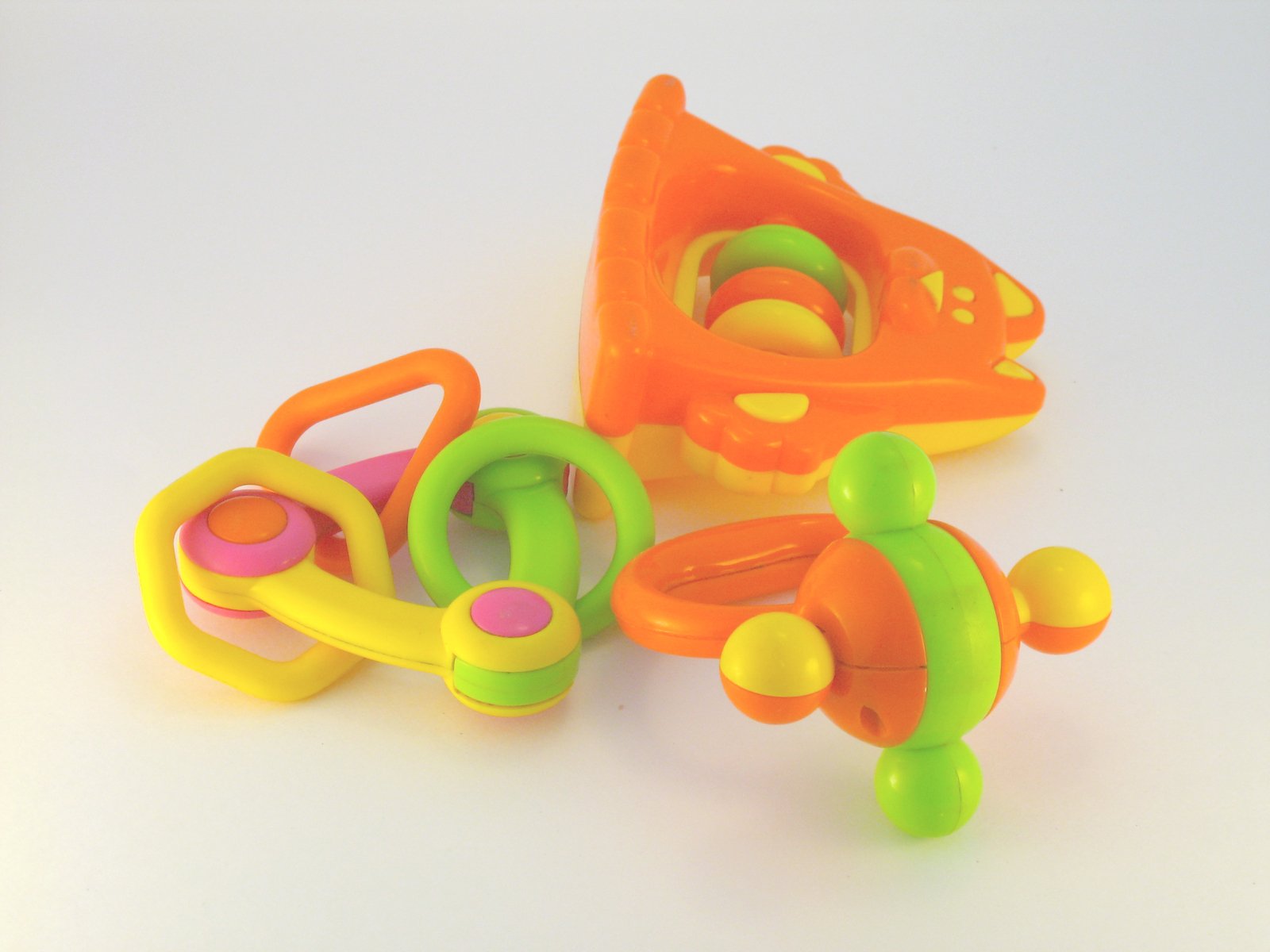 three plastic toy pieces lay on top of one another