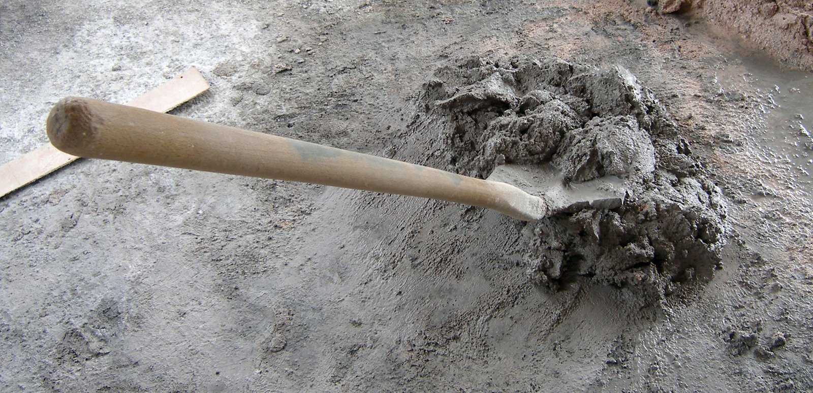 a baseball bat laying in the sand at the park