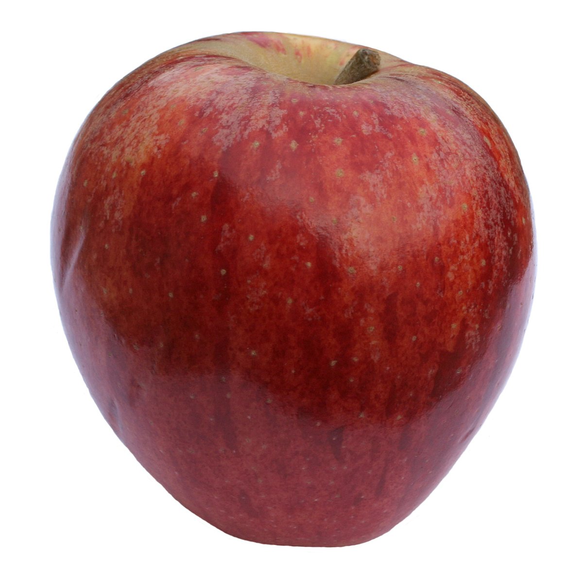 a big red apple with some dirt on it