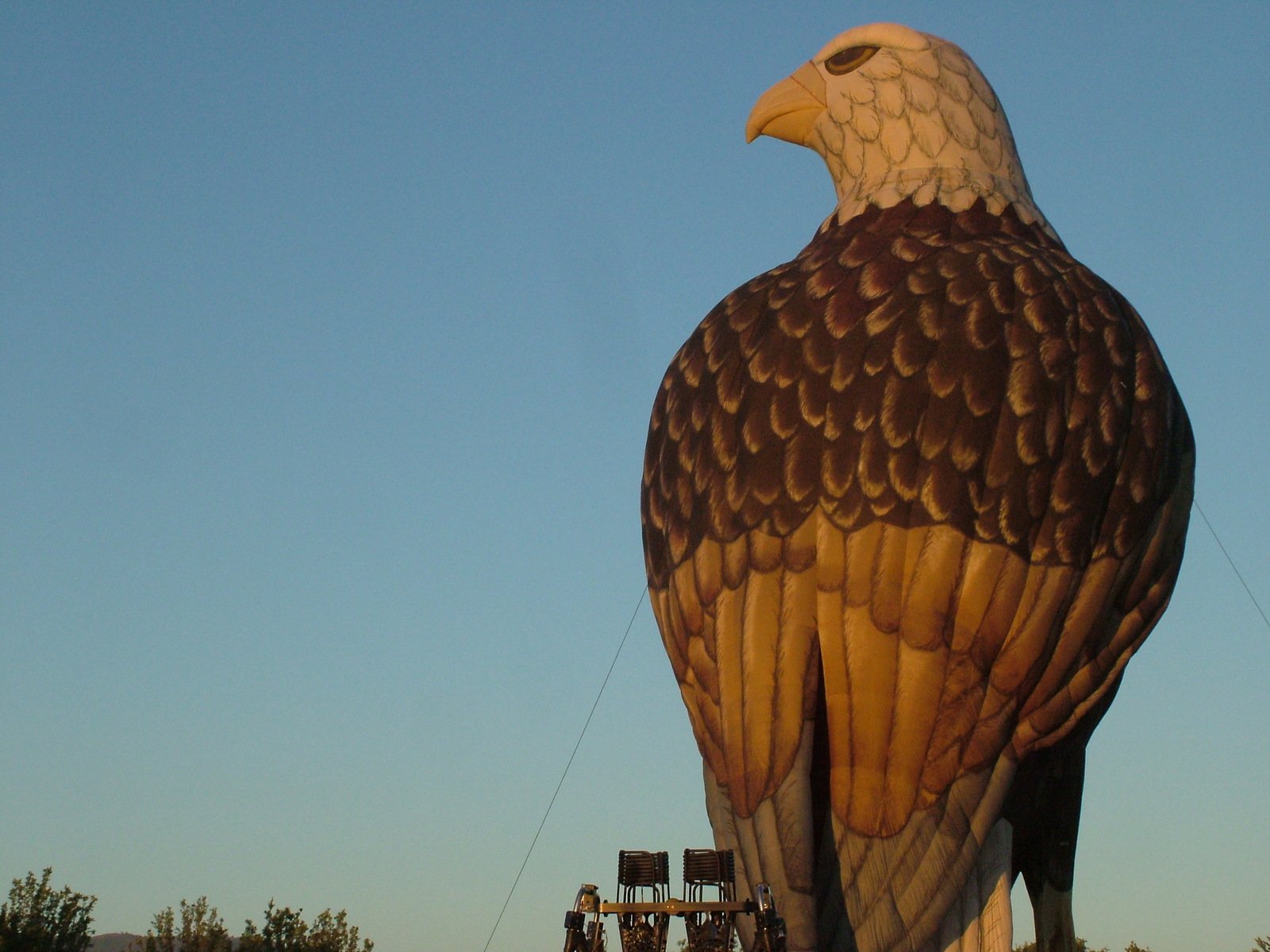 large eagle balloon sitting next to a large light pole