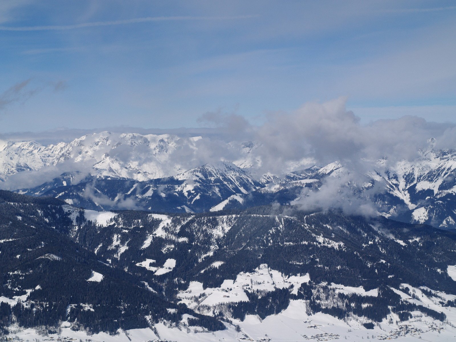 view from a airplane of some snow capped mountains