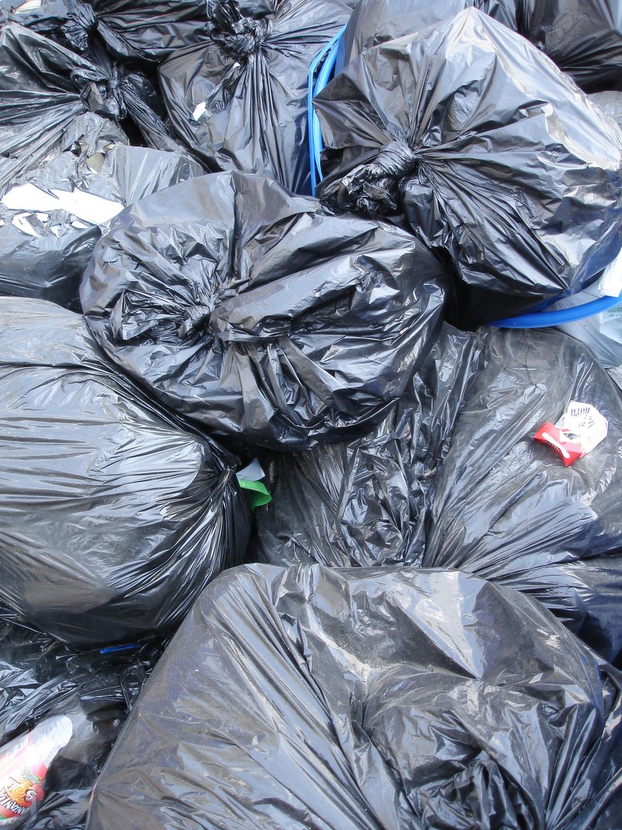 black garbage bags filled with a variety of different items
