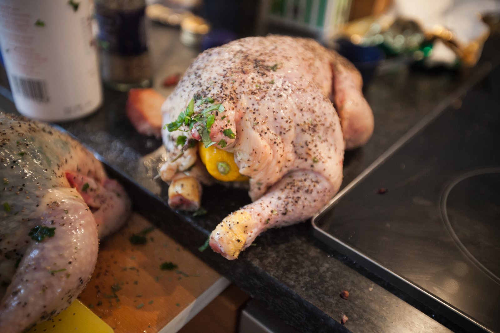 a closeup of a whole chicken on a black counter