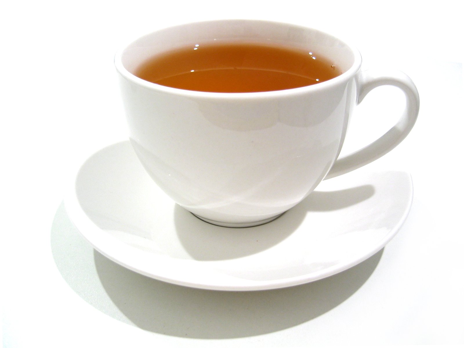 white cup of tea on a saucer on a table